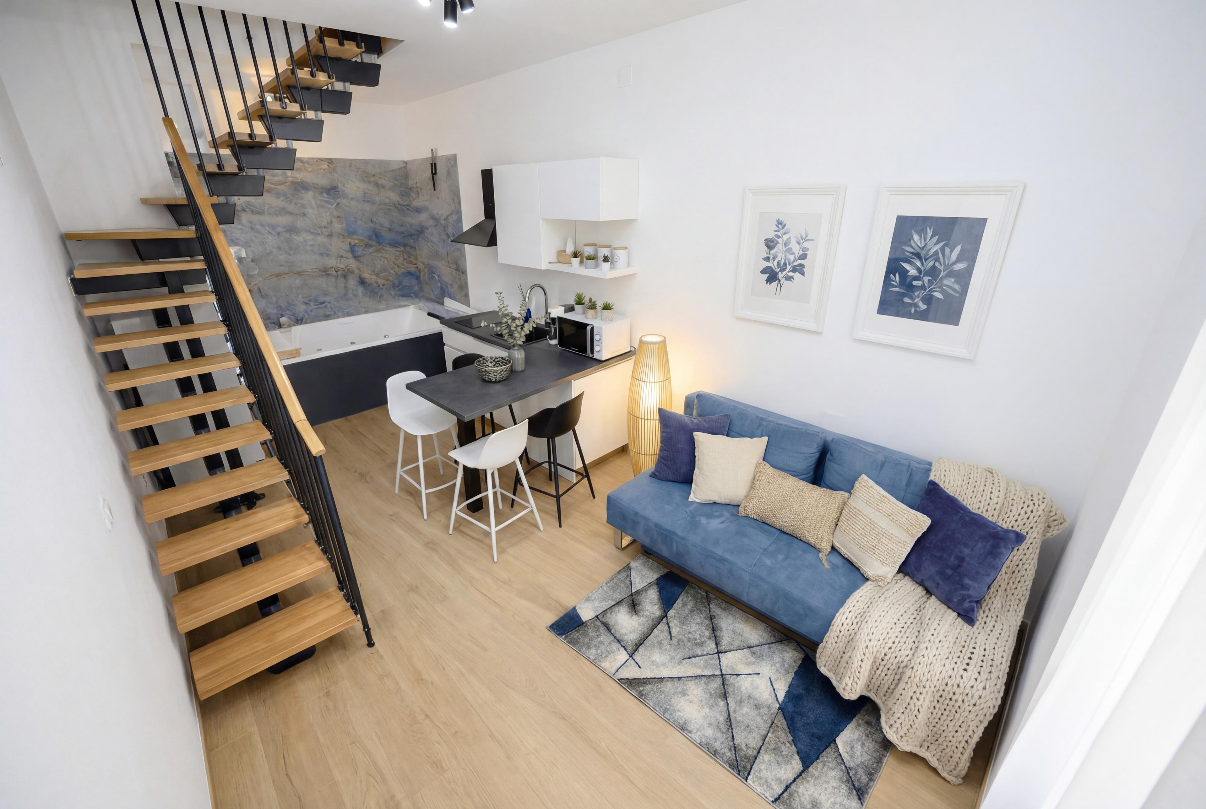 Mare apartment living area with blue sofa and designer interiors in Porto Cesareo