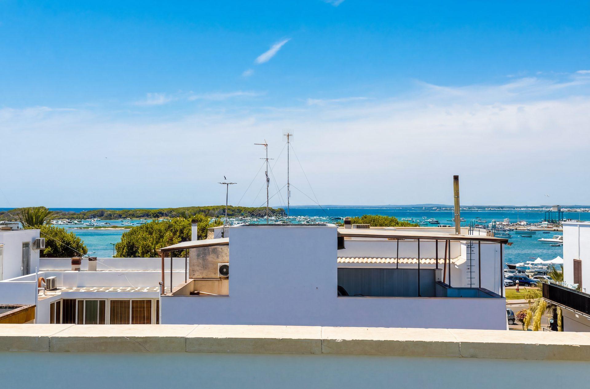 Mare apartment living area with blue sofa and designer interiors in Porto Cesareo