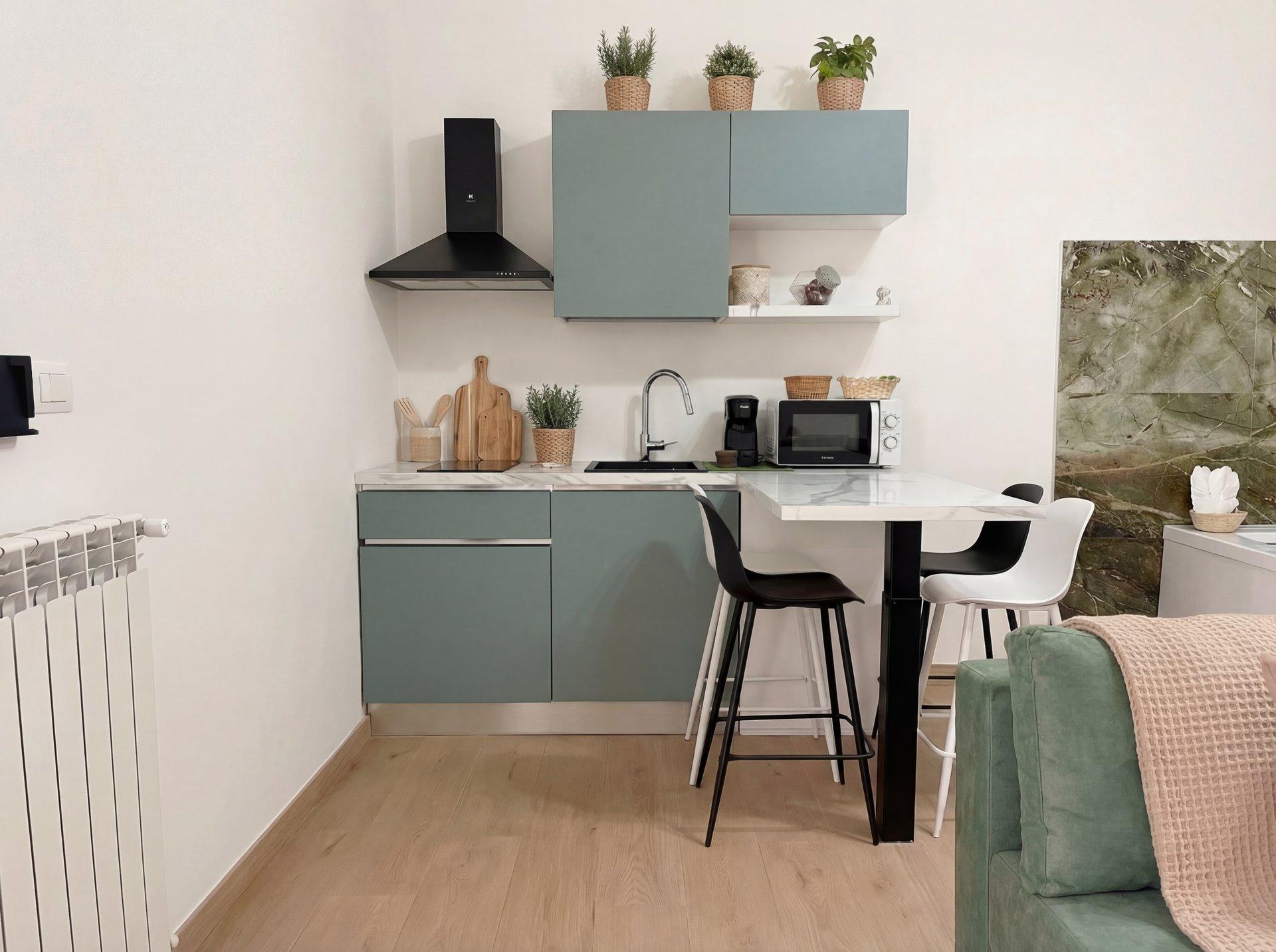 Fully equipped kitchen with induction hob, island seating, and modern finishes in Sunset Garden Terra, Porto Cesareo