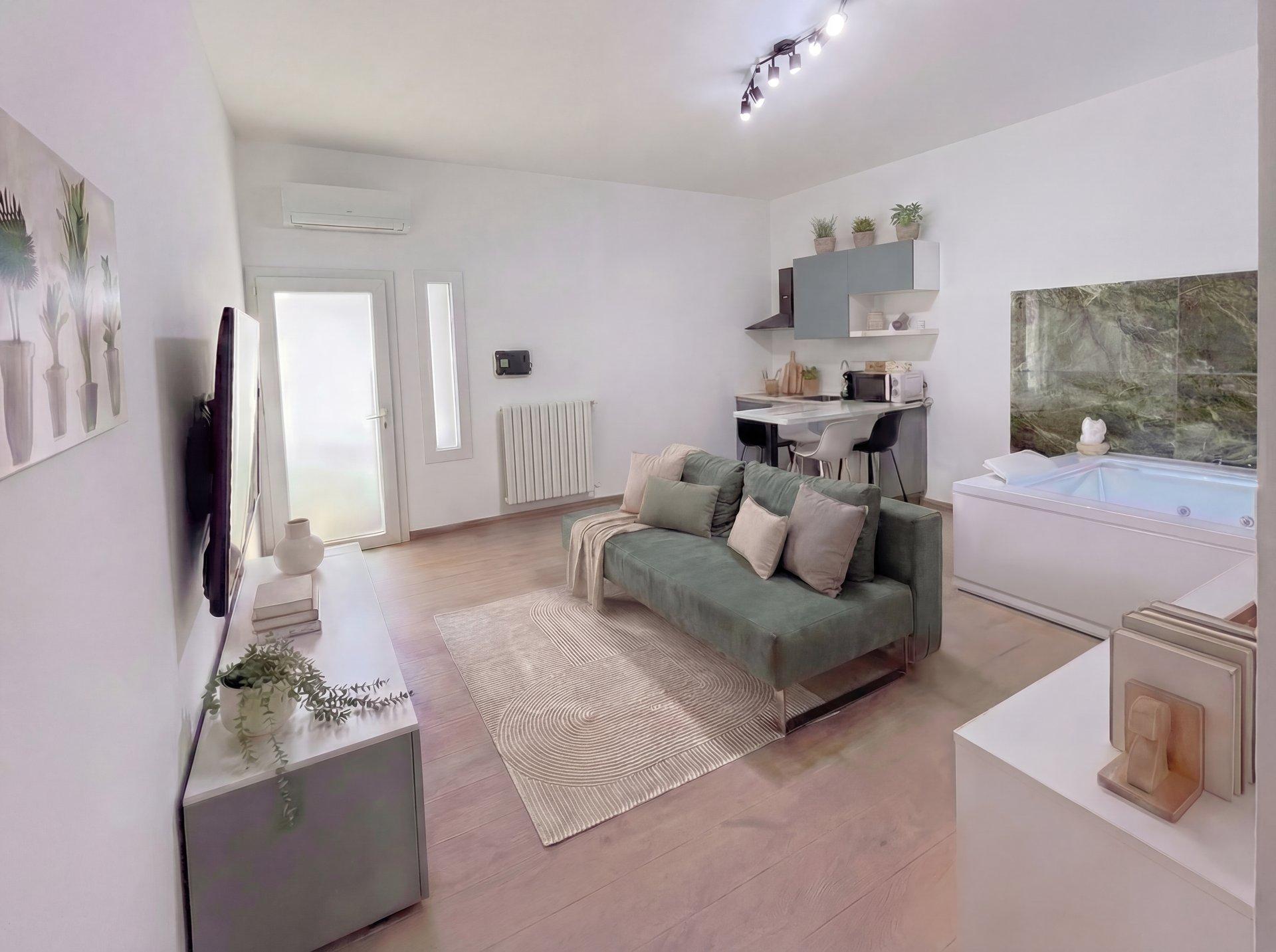 Living room with jacuzzi XL, modern furniture, and ambient lighting in Terra apartment, Porto Cesareo